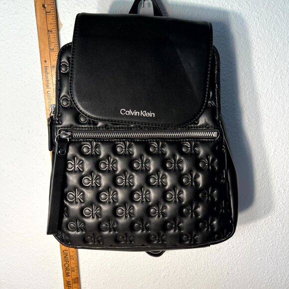 Calvin Klein Women's Black Reyna Signature Embossed Key Item Flap Backpack - Picture 1 of 6